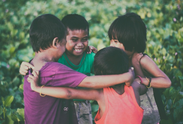 A group of children happily huddling together