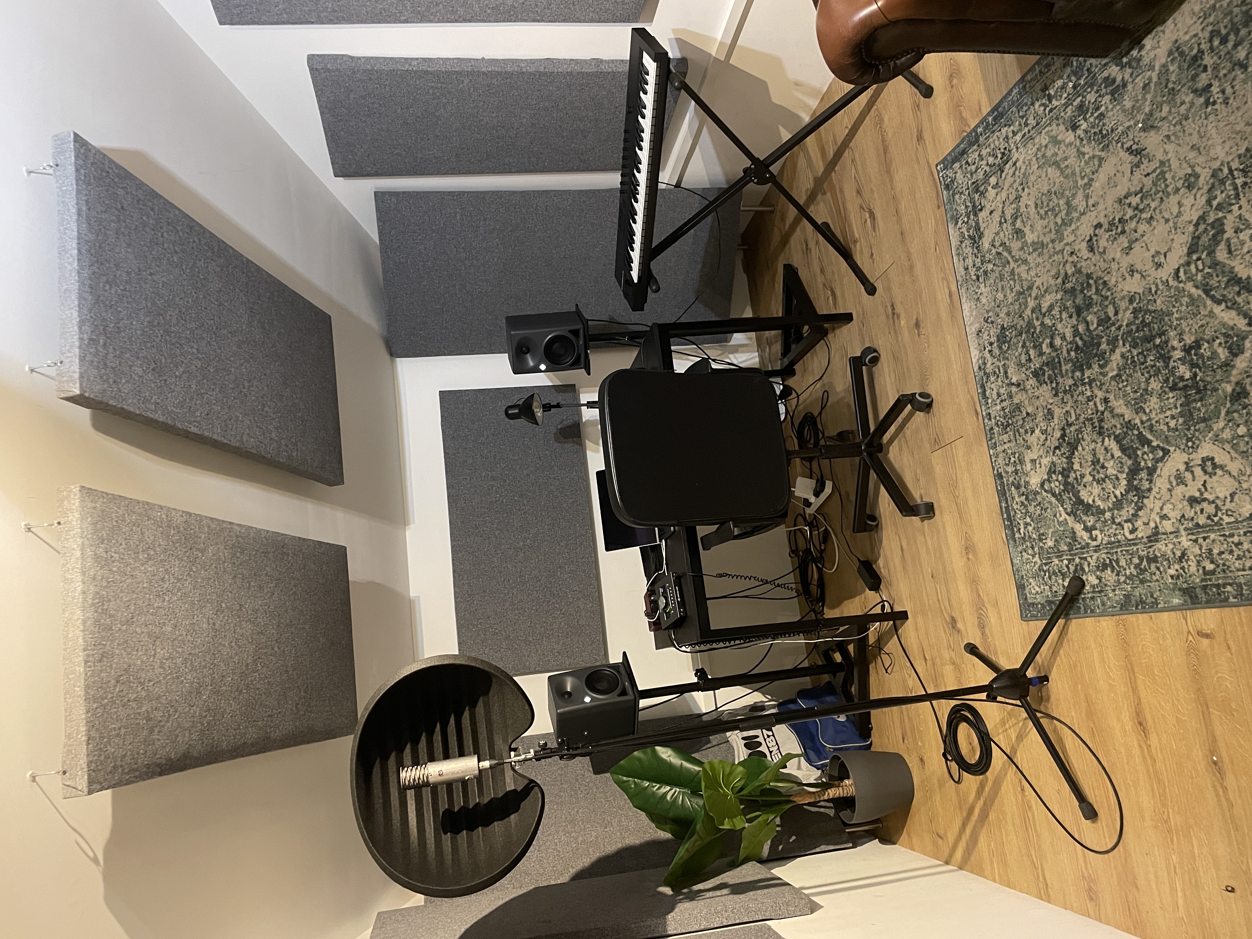 Laptop on a desk surrounded by speaker equipment. 