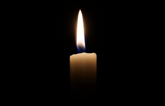 Lone candle with flame