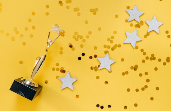 Award trophy with star on yellow background