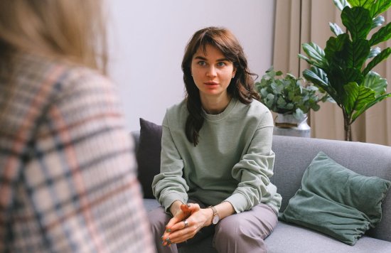 Stock image of a woman speaking to somebody.