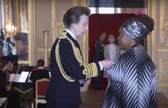 The Princess Royal presenting Lorraine Sunduza with her OBE.