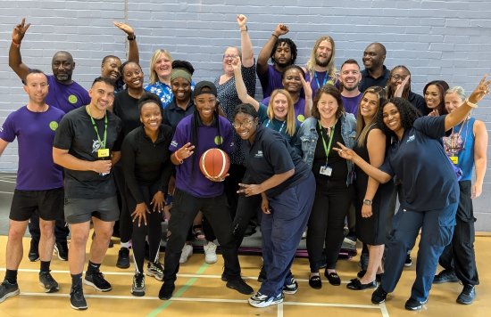 Some of the games volunteers smiling and cheering