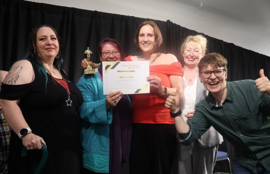 Group of staff with certificate and award